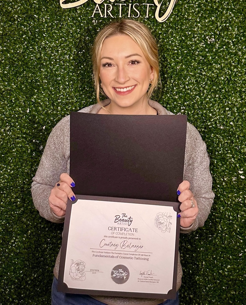 Photo of Courtney Belanger holding course completion certificate