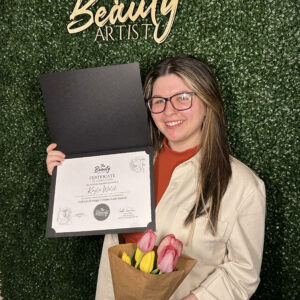 Photo of Kayla Welch holding course completion certificate