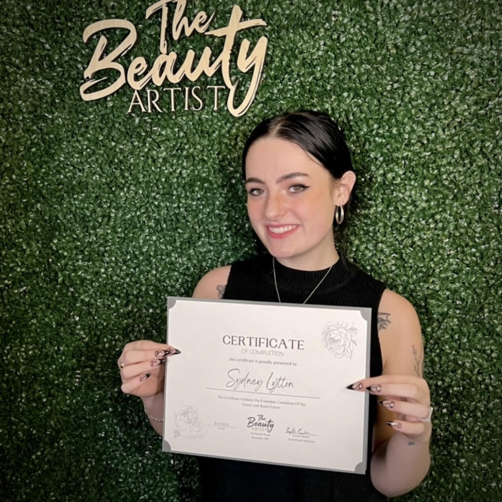 Photo of Sydney Lytton holding course completion certificate